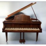 A baby-grand piano by John Adams, London, retailed by Harrods, No.60461, in walnut case, raised on