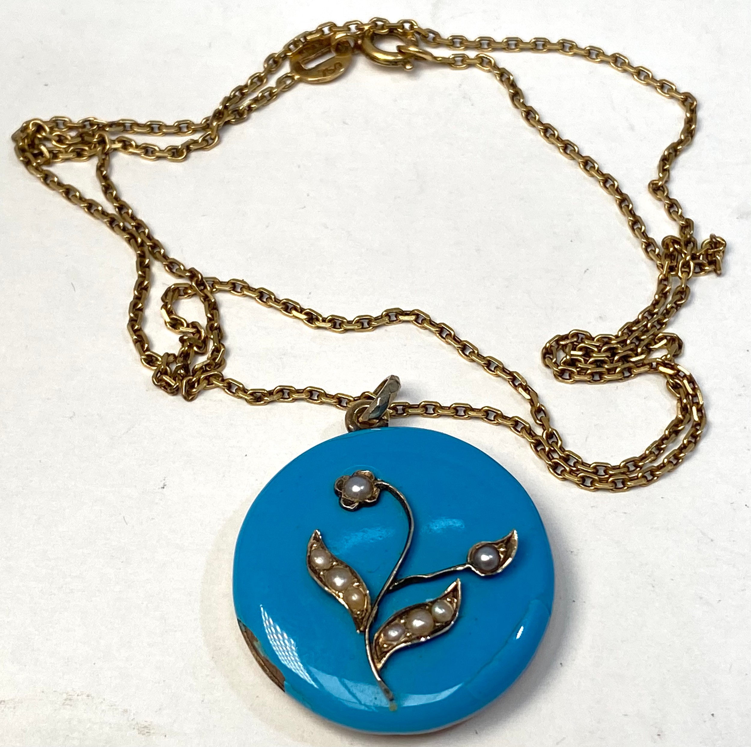 An 18ct gold chain with turquoise enamelled pendant, set with small seed pearls to the flower and