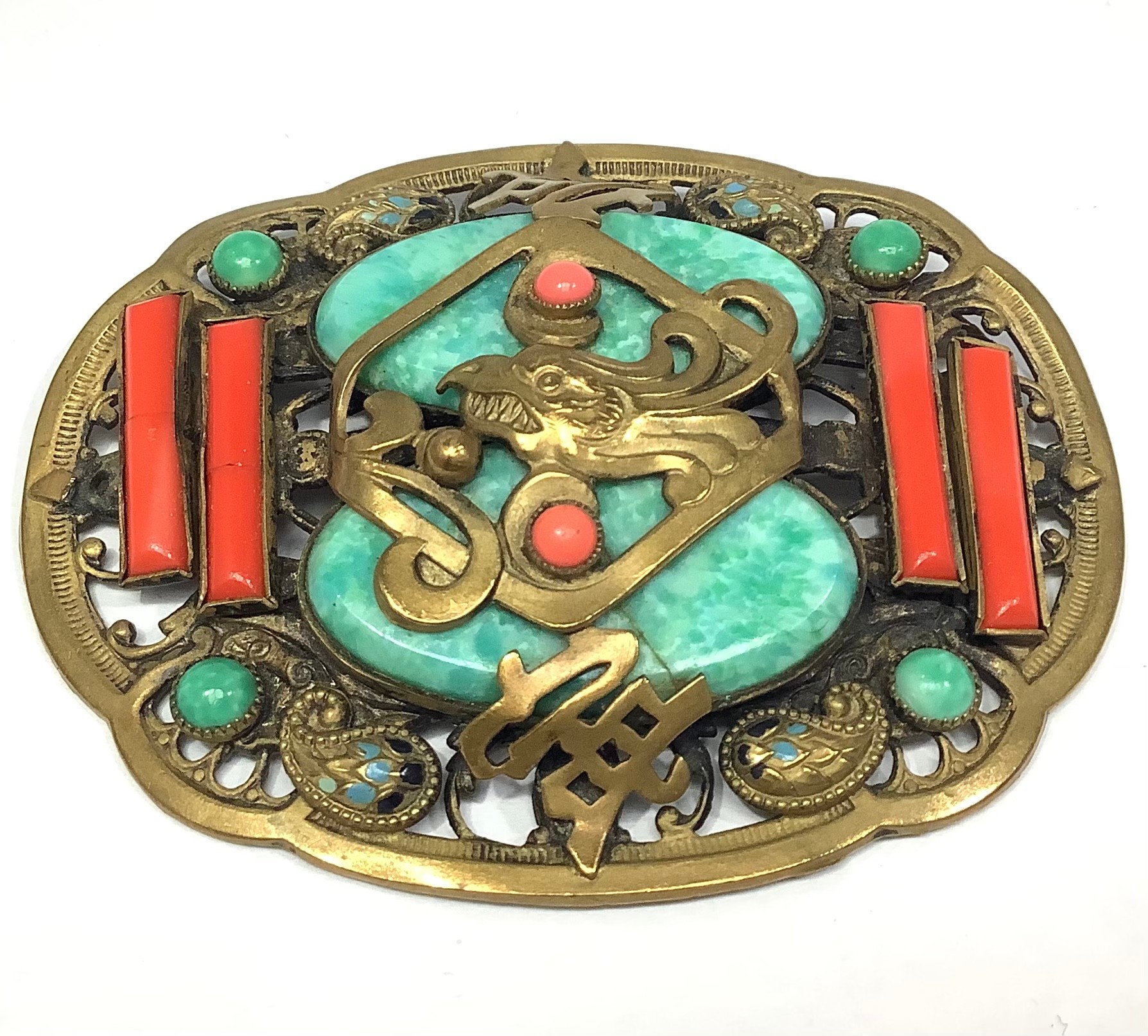 A 1930s gilt metal Chinese style shaped oval brooch probably by Max Neiger (brothers), central