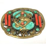 A 1930s gilt metal Chinese style shaped oval brooch probably by Max Neiger (brothers), central