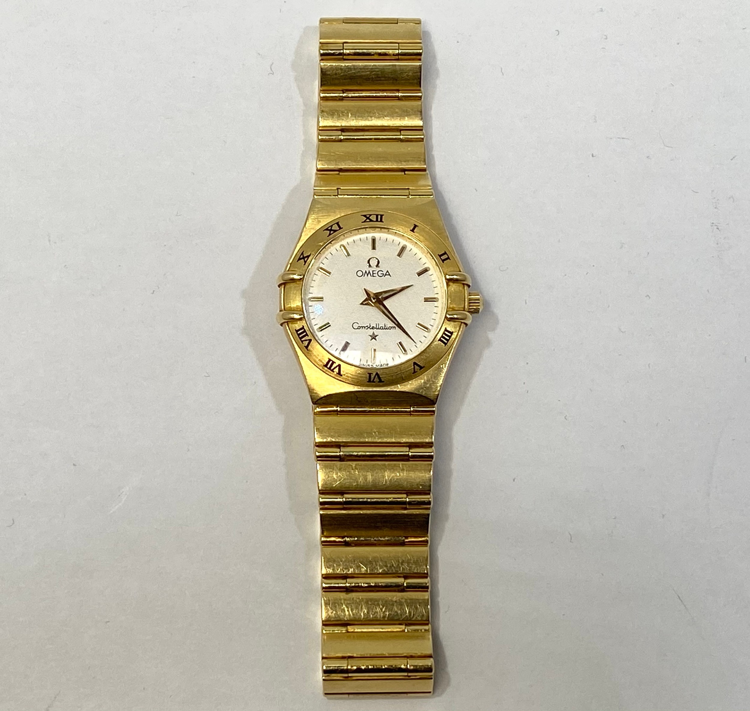 A ladies 18ct yellow gold quartz Omega Constellation wristwatch, the textured white dial with batons