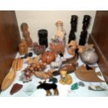 A collection of various wood and soapstone carvings including African candle sticks, ducks, grapes