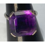A platinum dress ring, set with a square corner cut amethyst, weighing 3.0 grams, finger size S.