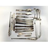 A small collection of assorted silver flatware comprising a pair of Georgian sugar tongs by Reid &
