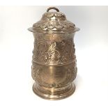 An early George III silver large lidded tankard with repousse scrollwork to the body, the cover with