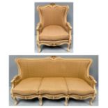 A contemporary off-white painted, French style three-seater settee, with gold painted accents and