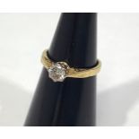 An 18ct gold and diamond solitaire ring, the round brilliant cut diamond spreading approx. 0.40