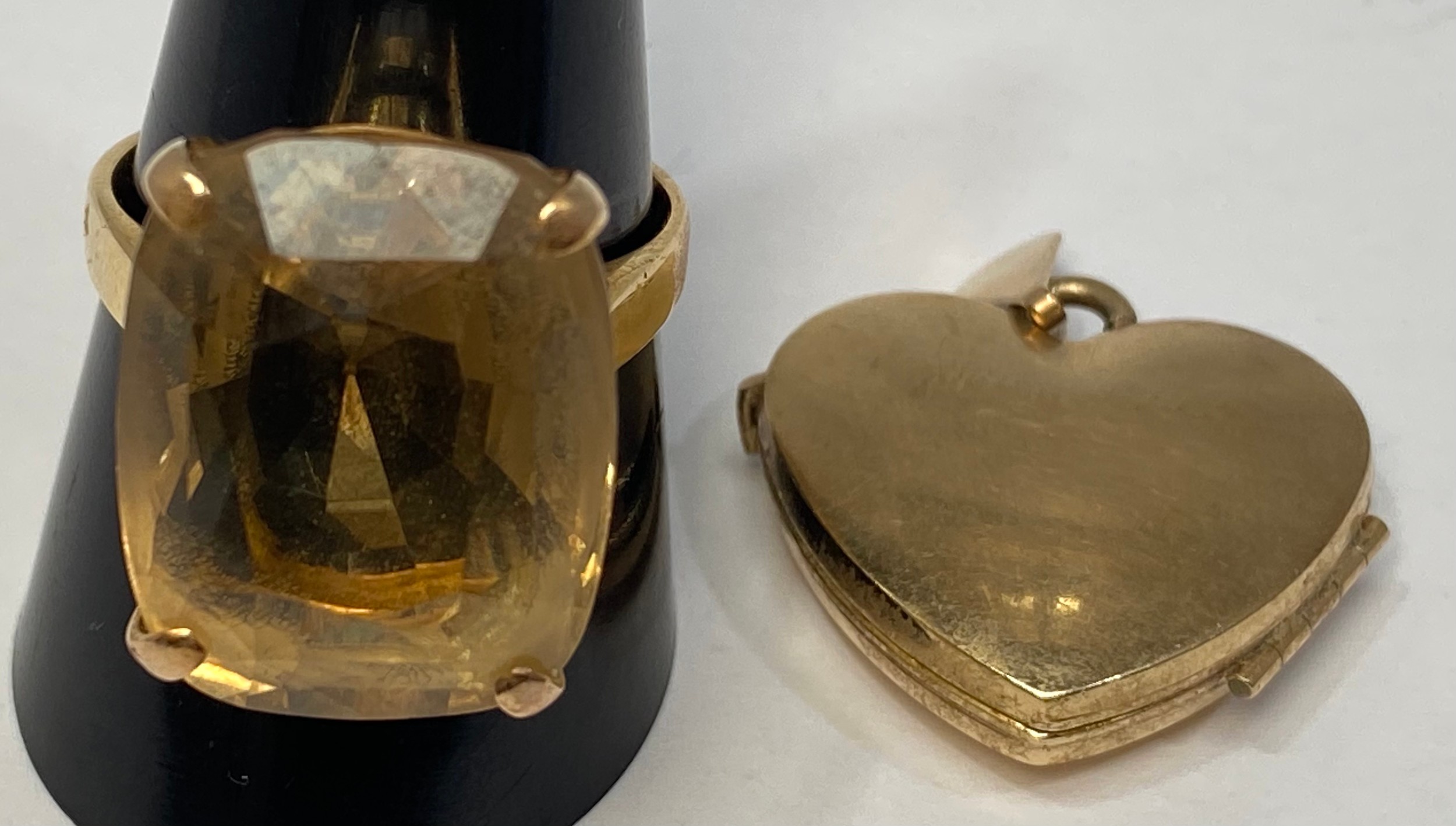 A 9ct gold locket, and a 9ct framed large Smokey quartz ring, finger size U, total weight 14.6