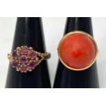 A 9ct gold dress ring set with 7 x small rubies in a daisy setting, with carved and shaped shank,