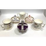 Six Royal Crown Derby porcelain items comprising three loving cups including 'Prince George Loving