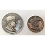 A pair of graduated silver medals by John Pinches, each depicting Sir Francis Chichester in