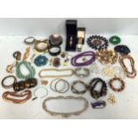 A large quantity of costume jewellery including bangles, necklaces, watches, rings, belt buckles and