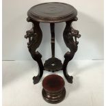 A black painted jardiniere stand raised on tripartite base with carved dragon to each leg,