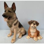 A resin model of a seated Alsatian dog, labelled Barkers Alsatian 90399, and a similar seated