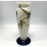 An Okra glass vase, of inverted baluster form, with shaped rim, decorated with leaves to a white