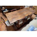 A stained oak refectory table, of rectangular form, raised on shaped trestle supports with