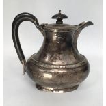 A George V silver hot-water jug, of oval baluster form, with ebonised finial and handle, Birmingham,