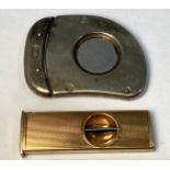 A 9ct gold cigar cutter with engine turned decoration, maker's mark C&C, together with a white metal