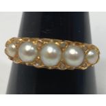 A 9ct gold ring set with five graduated blister-pearls, and 8 x small eight-cut diamonds in a carved