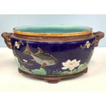 A Holdcroft majolica pottery oval jardiniere, moulded in relief with fish and flowers, with two