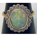 An 18ct gold opal and diamond ring, set with an oval fiery opal, measuring approximately 14mm x