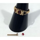 An 18ct gold ring set with four small diamonds and three ruby coloured stones (one loose), 2.5g,