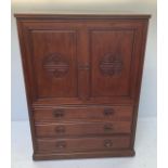 A 20th century Chinese rosewood two-door tv cabinet with drawers beneath, carved with auspicious