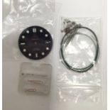 A collection of assorted replacement Omega wristwatch parts, some NOS including a Seamaster