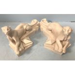 A pair of Art deco style white reconstituted marble recumbent panthers, raised on geometric lozenged