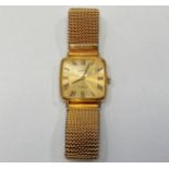 A gents yellow metal Omega wristwatch with square face and yellow metal dial and roman numerals,