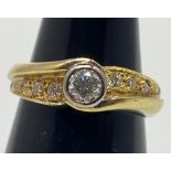 An 18ct yellow gold diamond ring, set with a round brilliant cut diamond in a rub-over bezel to