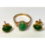 A 14ct gold ring, set with an oval shaped cabochon jade, in a four-claw setting, finger size J,