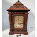 A 19th Century carved oak bracket clock by Walter Burton of Grimsby, the engraved silver dial with