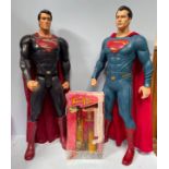 Two large Superman figures by Jakks, 80cm high, together with a Turboman doll from the film Jingle