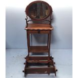 A mahogany oval toilet mirror, together with a stained oak rectangular occasional table, an open set