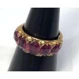 A gold and garnet ring, tests as 18ct, set with five graduated garnets, the largest measuring 7x6mm,