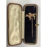 A 9ct gold stick pin mounted with a horse and jockey, gross weight approximately 5.5g