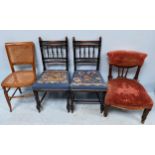 A pair of ebonised hall chairs, together with a caned chair and a red upholstered nursing chair etc.