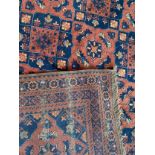 A large Afghan Samarkand pattern rug with geometric pattern in deep rouge, blue and cream colours.