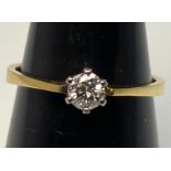 An 18ct yellow gold solitaire diamond ring, the round brilliant cut diamond being H in colour, VS1