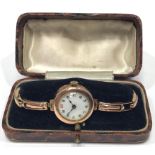 A ladies 9ct gold wristwatch, the white enamel dial with Arabic numerals denoting hours, on 9ct gold