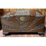 A camphor wood lined Chinese blanket chest, carved with scenes of figures and buildings, raised on