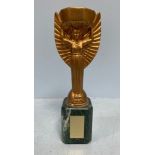 A replica Coupe Du Monde De Football Association trophy by Jules Rimet, 33cm high, together with a