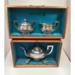 A three-piece silver tea set by Zee Sung of Shanghai, comprising a teapot, sugar bowl and cover