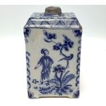 An 18th century Dutch Delft pottery tea canister, painted in underglaze blue with bird and figural