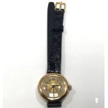 A ladies 15ct gold Rolex, the gold dial with Arabic numerals denoting hours, on black leather strap,
