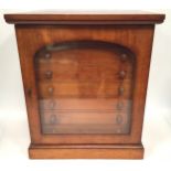 A stained mahogany collector's cabinet with glazed door enclosing seven drawers with turned pulls,