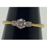 An 18ct yellow gold three stone diamond ring, all round brilliant cut diamonds being G in colour,