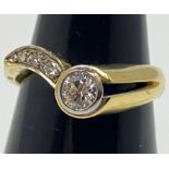 An 18ct yellow gold diamond ring, set with a round brilliant cut diamond in a rub-over setting, with
