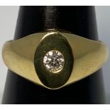 An 18ct yellow gold oval shaped ring, set with a round brilliant cut diamond to the centre, J
